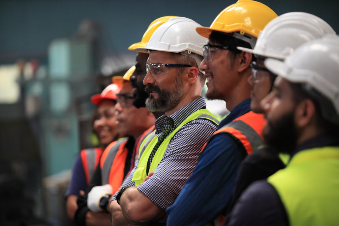 team of telecom technicians in vests and hard hats